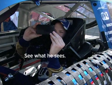 Brad Keselowski tweets from his car in a Twitter & NASCAR ad.